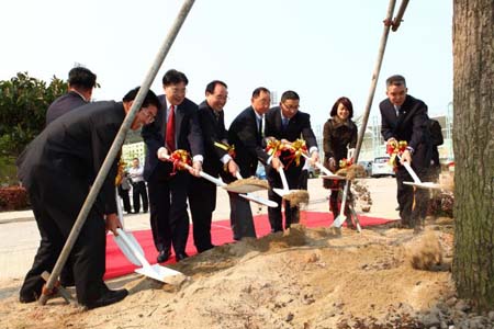 校領導與校友代表共同為樟樹培土